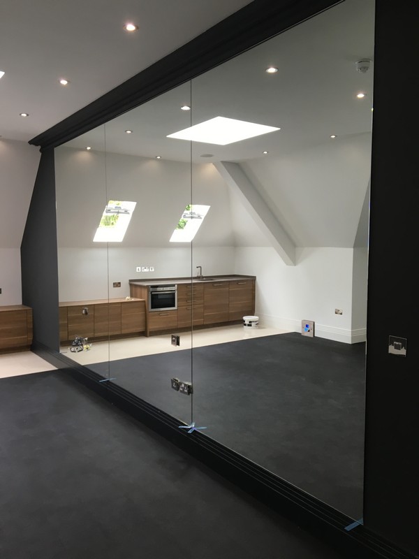 Frameless glass partition in loft conversion by Earlsfield glaziers