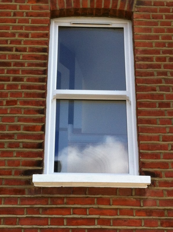 uPVC sash window on Victorian red brick house in Earlsfield